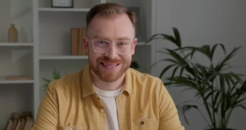 Casually dressed man with stylish eyeglasses and red beard looking at camera. Stock Footage 249181430