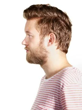 Casually handsome. A cropped profile of a bearded young man isolated on white. Stock Photos