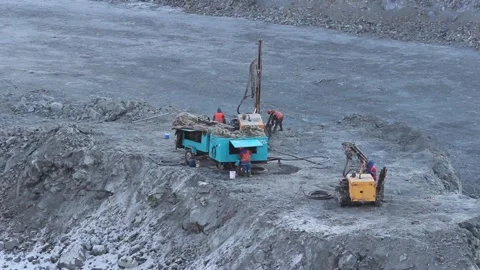 Cat 25Workers drillers prepare the rig for work in the quarry. Stock Footage 124192617