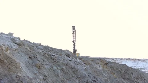 Cat 32The drilling rig does its job in an open pit. Drill is drilling. Stock Footage 124192729
