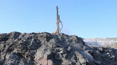 Cat 34The drilling rig does its job in an open pit. Drill is drilling. Stock Footage 124192751