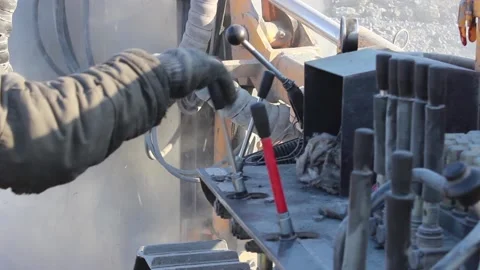 Cat 37The hands of the rig operator control the rig and the drilling process. Stock Footage 124192779