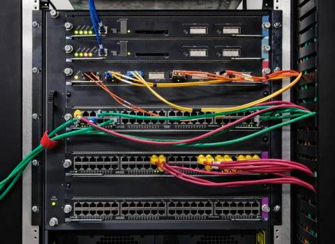 Cat 5 cables plugged into an individual server in a computer server farm. Stockfoto's