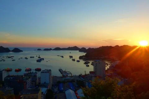 Cat Ba Island panorama overlooking port and fishing boats with a colorful sun Stock Photos