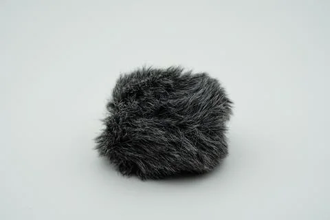 Cat feather attached to the microphone end, feather that prevents the micro.. Stock-Fotos