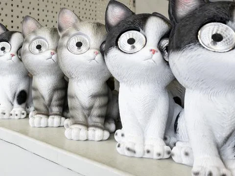 Cat figurines with flashlights Stock Photos