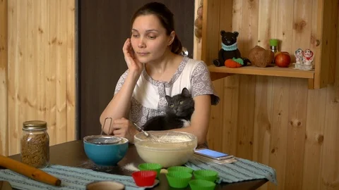Cat helps prepare cupcakes Stock Footage 86408634