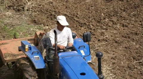 Cat-skinner on the tractor with a plough Stock Footage 23464686