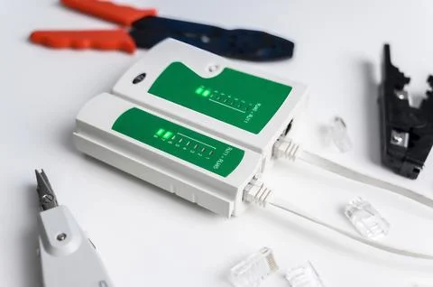Cat6 RJ45 cable network tester. Twisted pair test tool on the desktop. Stock Photos