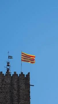 Catalan flag fluttering in the wind over the blue sky Stock Photos