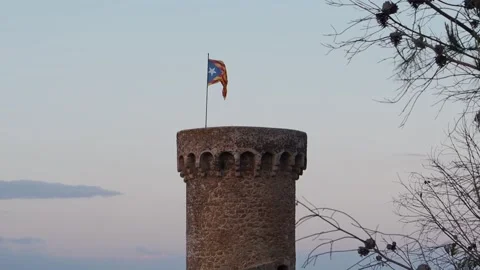Catalan independence flag flying on the tower of a castle in Catalonia. Estelada Stock Footage 260194943