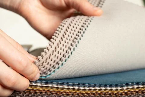 A catalog of different colors of fabrics in the hands of a girl for the cho.. Stock Photos