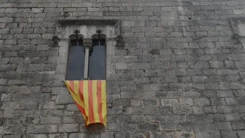 Catalonian flag waving from a gothic window frame Stock Footage 92323276