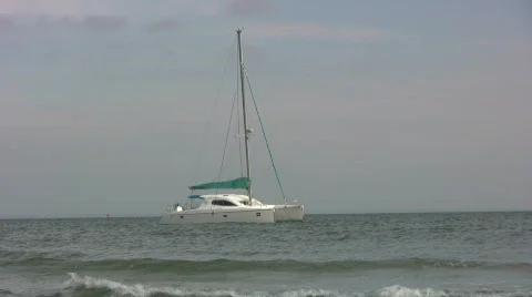 Catamaran anchored in breakers Video stock 271753