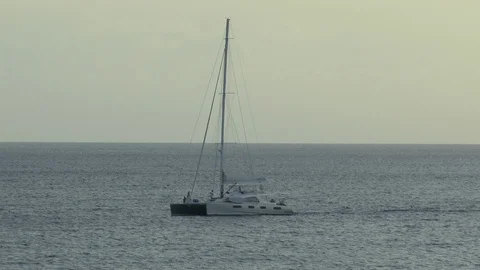Catamaran off of Barbados Early Evening Light Stock Footage 107560329