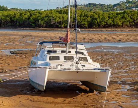 Catamaran Beached In The Mud At Low Tide Stock Photos