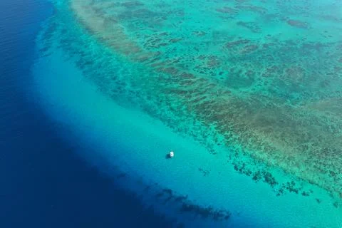 Catamaran on caribbean ocean with coral reef and deep sea Stock Photos