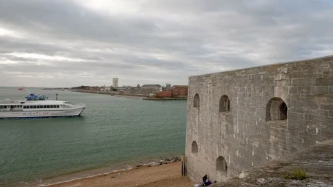 A catamaran ferry passes the Round Tower in Portsmouth Stock Footage 126024721