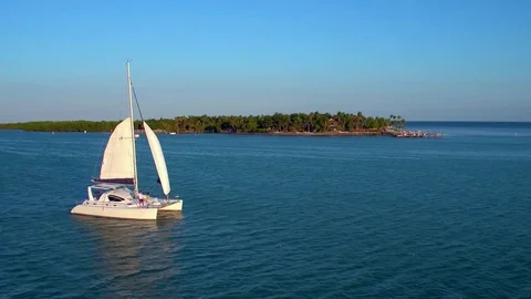 Catamaran in Front of Tropical Island Stock Footage