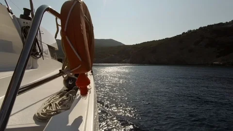 Catamaran Sailboat side view of the hull in navigation with sun in backlight Stock Footage 95833604