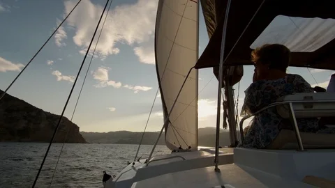 Catamaran Sailboat, view of the deck and the sails during navigation at sunset. Stock Footage 95834447