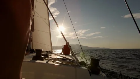 Catamaran Sailboat, view of the deck and the sails at sunset Stock Footage 95835219