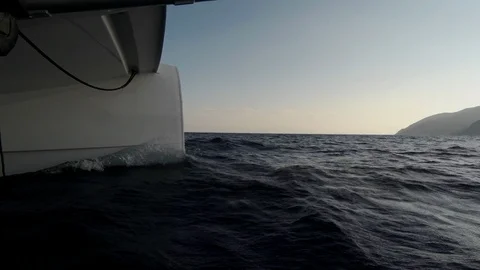 Catamaran Sailboat view from side of the bow into the waves Stock Footage 95834716