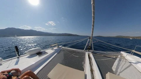 Catamaran sailing with a couple relaxing in the bow, 360 effect Stock Footage 120785201
