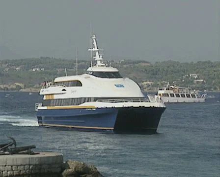 Catamaran slowly arrives at Spetses harbour Stock Footage