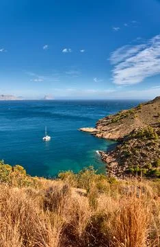 Catamaran view from Old Lighthouse Trail near Peñón de Ifach, Albir, Spain Stock Photos