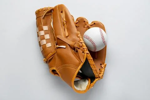 Catcher's mitt and baseball ball on white background, top view. Sports game Stock Photos