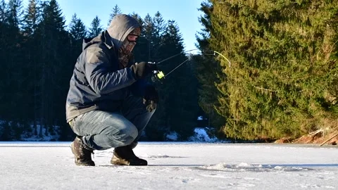 Catching brown trout on ice, ice fisherman Stock Footage 265602988