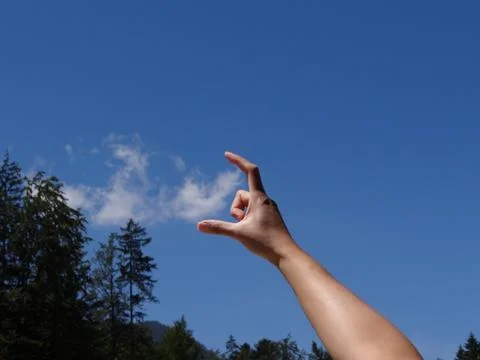 Catching clouds with hand Stock Photos