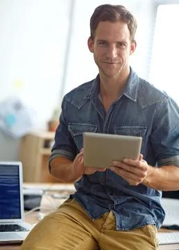 Catching up on emails before work. A young man reading his text messages while Stock Photos