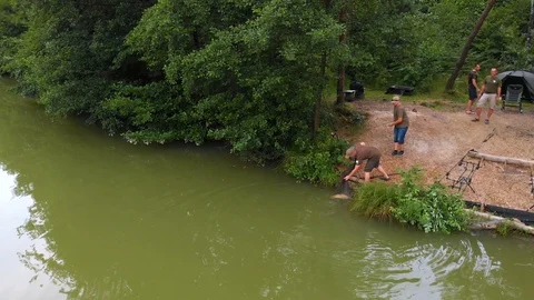 Catching a fish and trying to get it out of the water Stock Footage 112179571