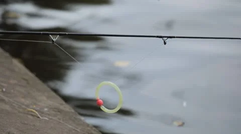 Catching fish by a fisherman using spinning reels on a lake in countryside Stockbeeldmateriaal 8930704
