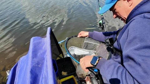 Catching fish in the river during a sunny day in a local fishing spot Stock Footage 335889248
