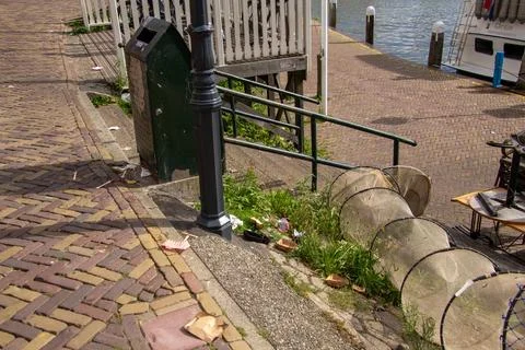 Catching garbage in a garbage bin or in a fishing net. Stock Photos