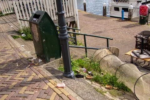Catching garbage in a garbage bin or in a fishing net. Stock Photos