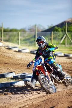 Catching up to the leader. A motocross rider skidding down the track. Stock Photos