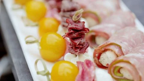 Catering appetizers arranged on white rectangular plate, showcasing skewered Stock Photos
