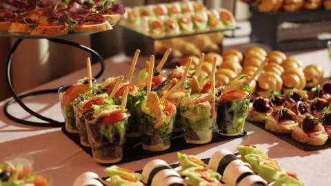 Catering buffet with assorted finger food and appetizers at event Stock Footage 324571073