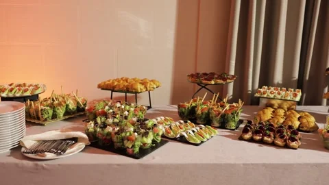 Catering buffet table with assorted appetizers and finger food at event Stock-Footage 324571425