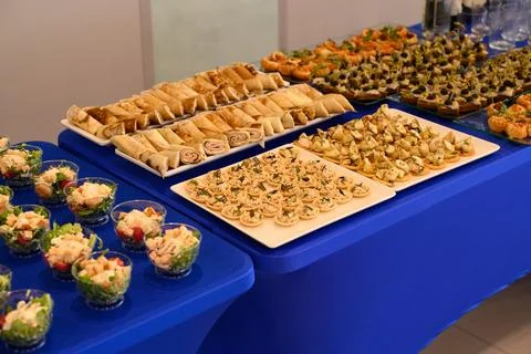 Catering buffet table with assortment of savory appetizer snacks including .. Stock Photos