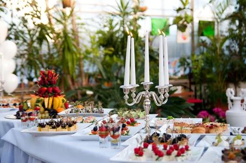 Catering buffet table with snacks and appetizers. Dessert with fresh fruit on Stock Photos