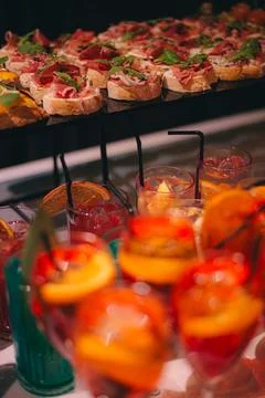 Catering buffet table with snacks and appetizers. Set of canapes with jamon Stock Photos