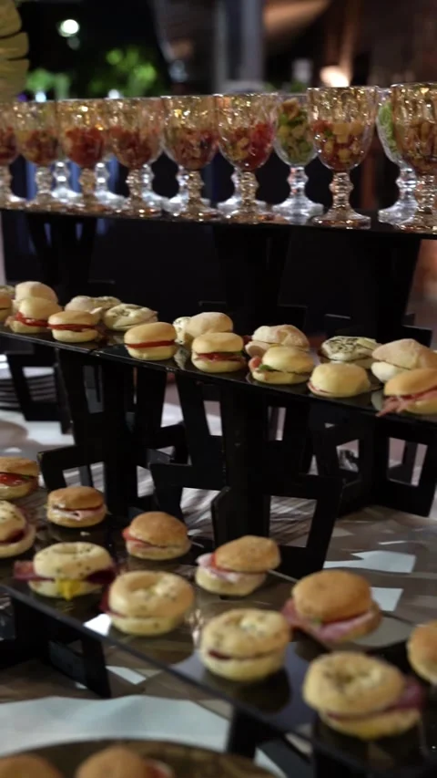 Catering reception table featuring rows of appetizers Stock Footage 336639622