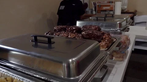 Catering Table with Foil Wrapped Dishes Alongside Macaroni and Green Beans Stock-Footage 338119881