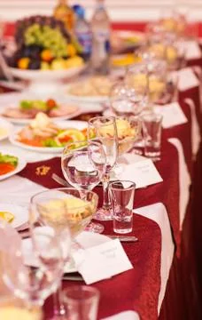 Catering table set service with silverware, napkin and glass at restaurant Stock Photos