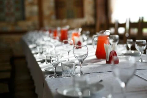 Catering table set service with silverware, napkin and glass at restaurant Stock Photos